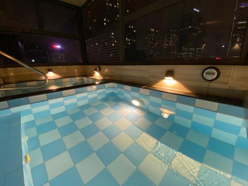 a swimming pool on top of a building at night at Hotel Yah Hanoi & Spa in Hanoi