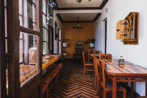 a dining room with wooden tables and chairs at La Culta hostal & centro cultural in Sucre