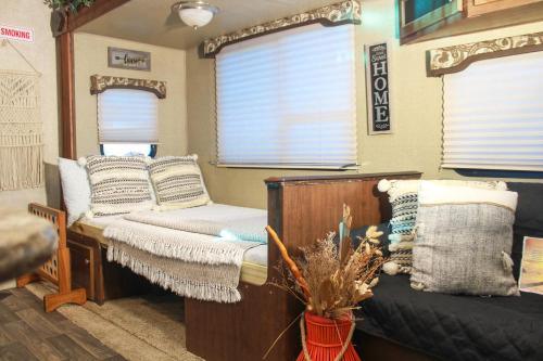 a living room with a bed and a couch at Brisas de Isabela Cozy Glamper 1 in Isabela