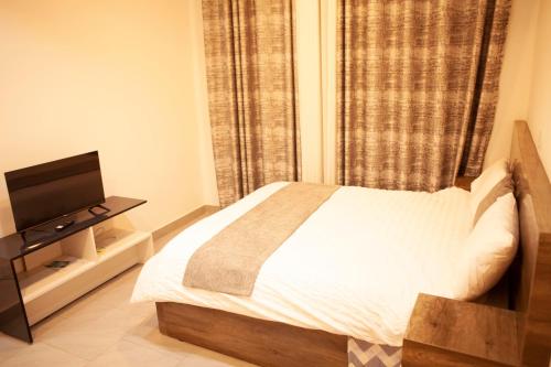Ein Bett oder Betten in einem Zimmer der Unterkunft Kigali bright villa1