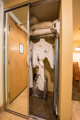 a room with a closet with a shirt and clothes at The Grand Lodge Hotel and Suites in Mount Crested Butte