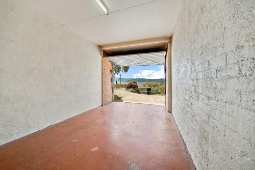 an empty hallway with an open door to a building at Snowbird 1 - Charming 2BR Townhouse l Lake Views l Air-Con l Off-Street Parking in Jindabyne