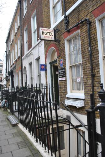 a hotel sign on the side of a brick building at Grenville House Hotel in London
