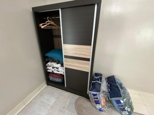 a black closet with a mirror in a room at Homestay Aalaiya Bertam Kepala Batas - Fully Aircond in Kepala Batas