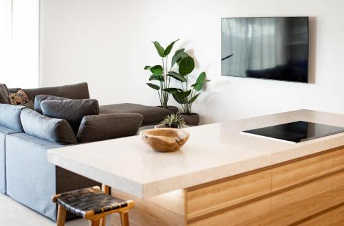 a living room with a table and a couch at BreakFree Royal Harbour in Cairns