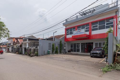 a street view of a building with a parking lot at RedDoorz Syariah near DPRD Kabupaten Subang in Subang