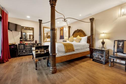 a bedroom with a large bed and a desk and a mirror at Quiet Mind Mountain Lodge, Retreat & Spa in Julian