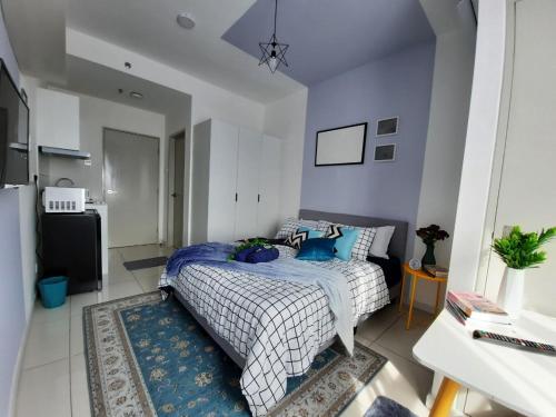 a bedroom with a bed with blue pillows on it at Horizon Suites Near KLIA Airport (B) in Sepang