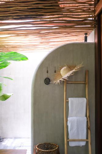 a room with a wooden ladder and a towel at Amaka Villas in Uluwatu