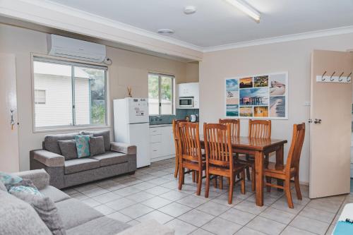 a kitchen and dining room with a table and chairs at Dongara Hotel Motel in Dongara
