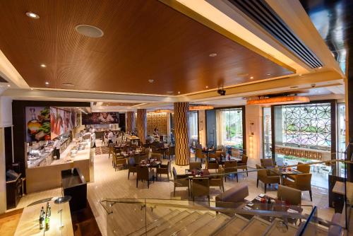 a restaurant with tables and chairs in a building at Shangri-La Bangkok in Bangkok