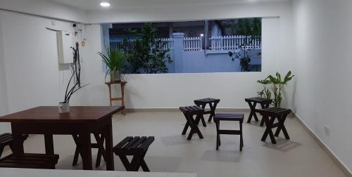 a room with chairs and a table and a table and chairs at Hotel Serugahawatta in Wellawaya