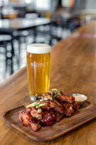 a plate of food with a glass of beer at The Cambie Hostel Seymour in Vancouver
