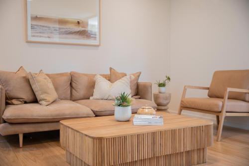 a living room with a couch and a coffee table at Great Ocean Road Resort in Anglesea