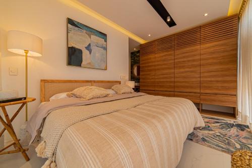 a bedroom with a large bed and a window at Mako 54 in Puerto Vallarta