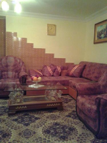 a living room with a couch and a table at Lux Apartment in Yerevan