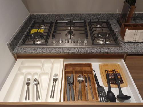a kitchen counter with a stove with utensils on it at Mako 54 in Puerto Vallarta