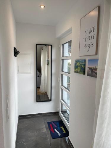 a hallway with a mirror and a window at Fewo Burg,Mosel,Tal-Blick in Cochem