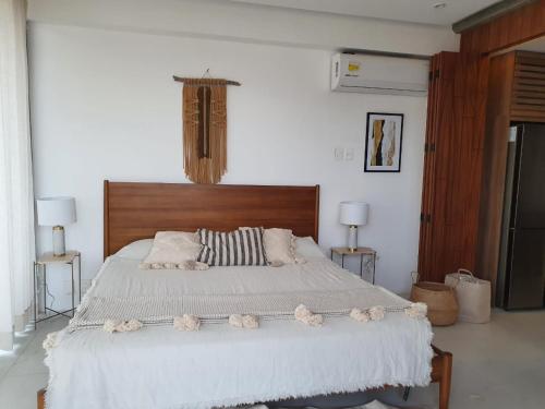 a bedroom with a large bed with white sheets and pillows at Mako 54 in Puerto Vallarta