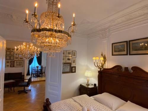 a bedroom with a bed and a chandelier at 7th HEAVEN Vienna Center Apartments in Vienna