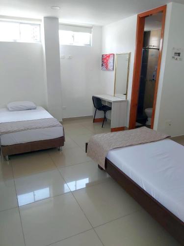 Postel nebo postele na pokoji v ubytování HOTEL DON QUIJOTE