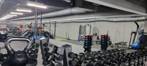 a gym with lots of equipment in a room at Park Hotel Viasport in Gorni Dŭbnik