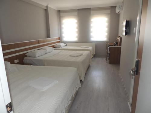 A bed or beds in a room at Sogutpark Hotel