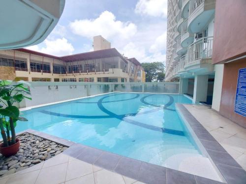 a large swimming pool in the middle of a building at Cityland Prime Residences by KF in Tagaytay