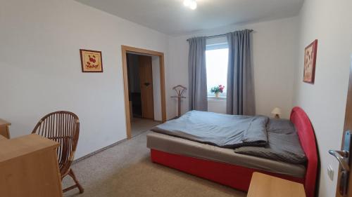 a bedroom with a bed and a table and a window at Baranie Wzgórze Ustroń Basen Sauna Plac Zabaw in Cisownica