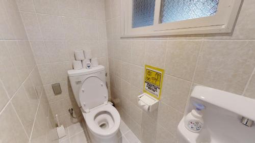 a bathroom with a toilet and a sink at Suminchu House Ichariba in Naha