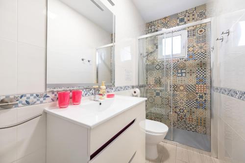 a bathroom with a sink and a toilet and a shower at Maria I Apartment with private pool in Torrevieja
