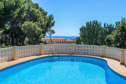 a swimming pool with a fence around it at NEO - sea view villa with private pool in Moraira in Teulada