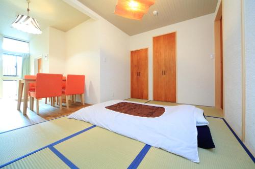 a bedroom with a bed and a table and chairs at 柏・二条1（Haku Nijo1） in Kyoto