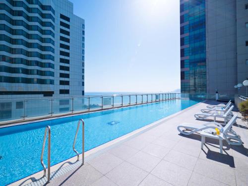 a swimming pool on the roof of a building at Kolon Seacloud Hotel in Busan