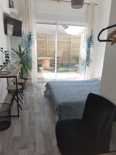 a bedroom with a bed and a desk and a chair at Chez Flo&Fred in Barbery