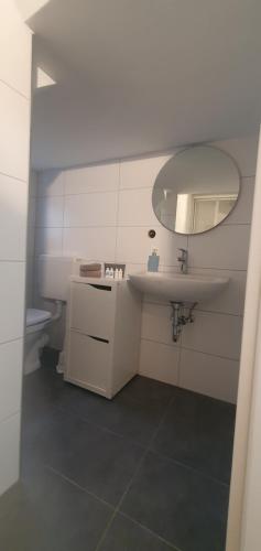 a bathroom with a sink and a mirror at Ferienhaus Sonni in Boppard