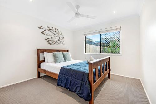 a bedroom with a bed and a window at Palm Beach Haven in Gold Coast