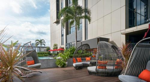 a hotel patio with chairs and a pool at Amari Kuala Lumpur in Kuala Lumpur