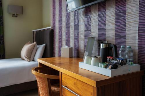 a room with a desk with a computer on it at Esplanade Hotel Llandudno in Llandudno