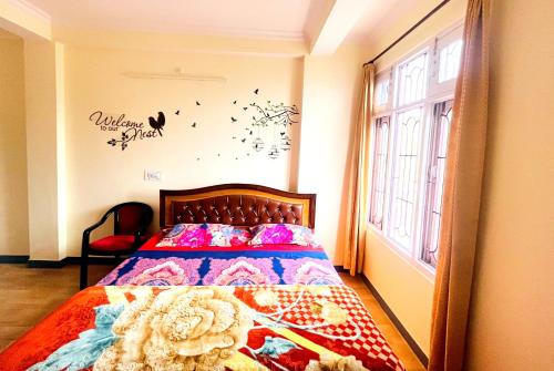 a bedroom with a bed and a window at Frosty Woods Homestay in Shimla