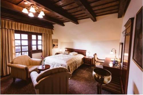 a large bedroom with a bed and a couch at Hotel Strk in Murska Sobota