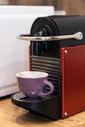 a purple cup is sitting inside of a toaster oven at Appartamenti Del Borgo in Borgosesia