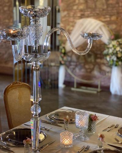 a table with a glass candle holder on top of a table at Panderma Port Hotel in Bandırma