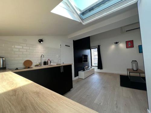 a large kitchen with a skylight in a room at L'Écrin de Bayard - Studio climatisé hyper-centre in Toulouse