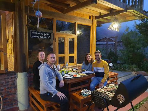 a group of people sitting at a table outside a restaurant at La Beauté Sa Pa in Sa Pa