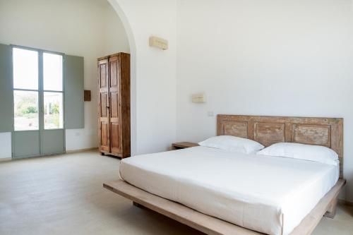 Letto o letti in una camera di Masseria Berzario
