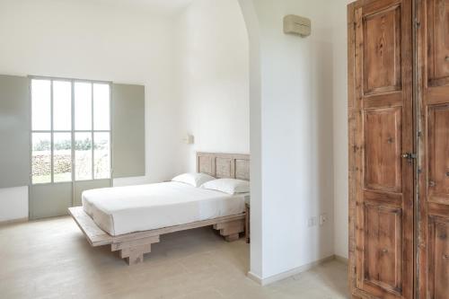Letto o letti in una camera di Masseria Berzario