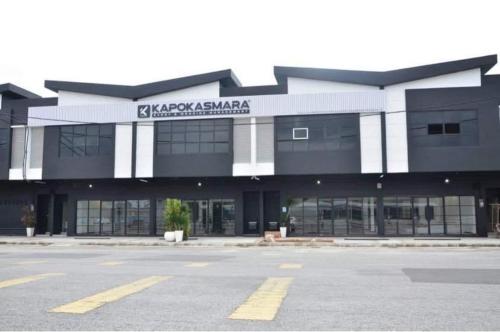 a large black and white building with a parking lot at Homestay Aalaiya Bertam Kepala Batas - Fully Aircond in Kepala Batas