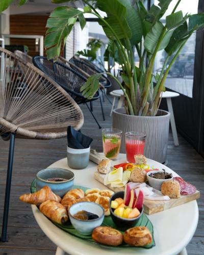 a table topped with a tray of bread and pastries at Torbole Aparthotel in Nago-Torbole