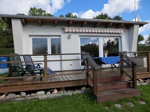 a large wooden deck with two chairs and a table at Ferienhäuschen Hochufer in Lohme